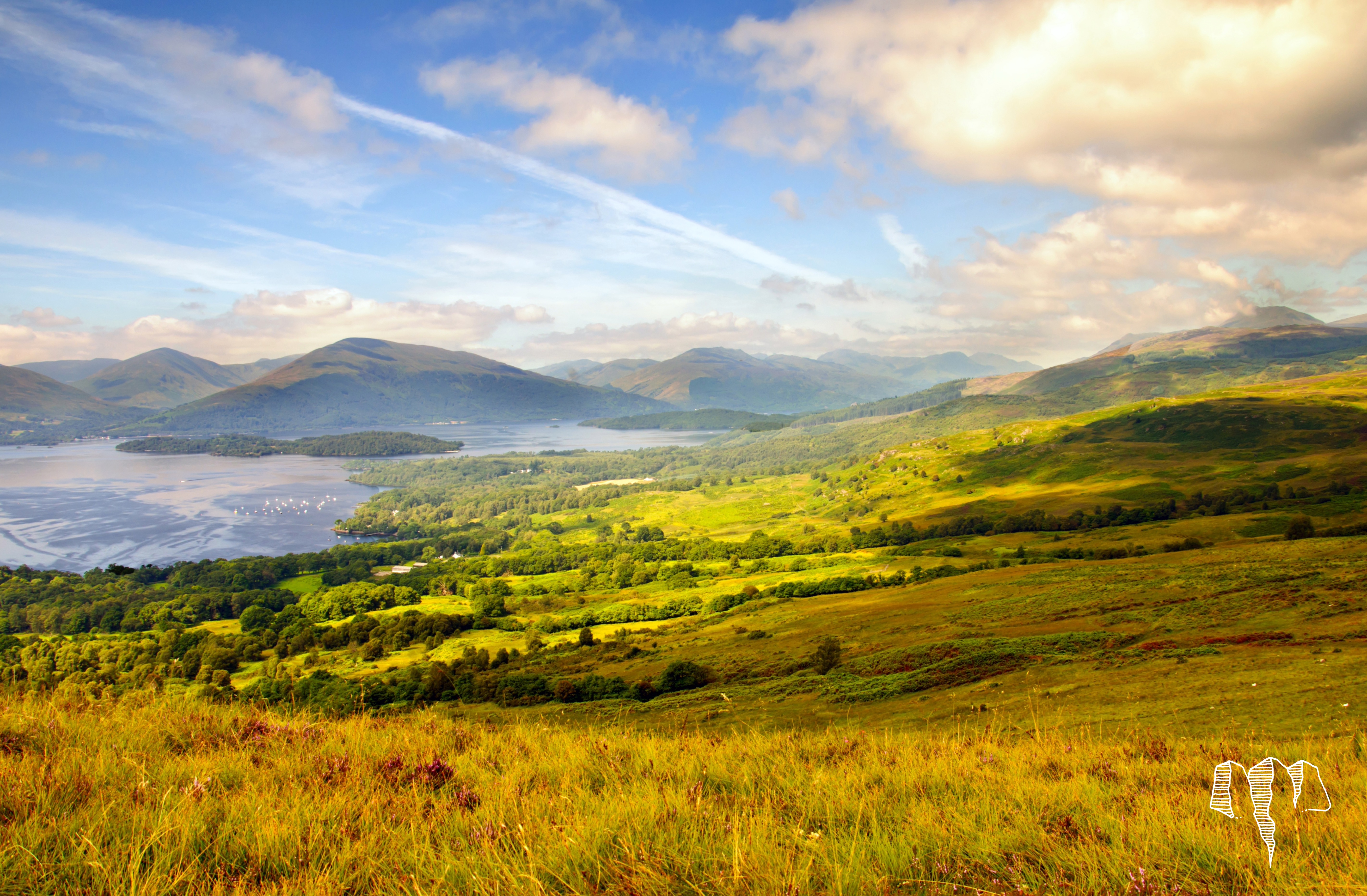 Loch Lomond surround by grasslands and mountains in Scotland